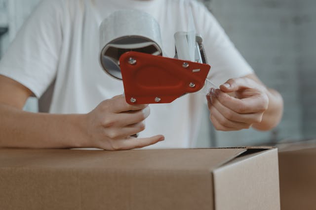a person taping a box